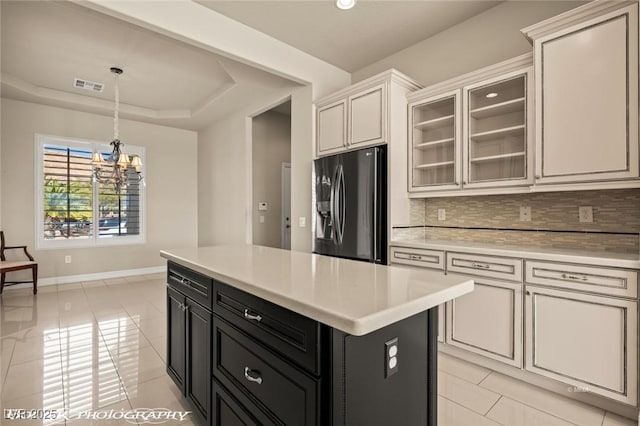 1348 Basin Vw, Mesquite, NV 89034 - kitchen featuring stainless steel fridge, dark cabinets, light countertops, decorative backsplash, and baseboards