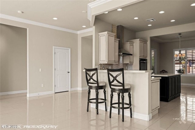 kitchen with a peninsula, wall chimney range hood, oven, visible vents, and crown molding