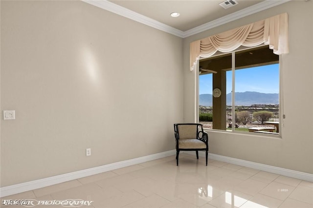 sitting room featuring crown molding, baseboards, a mountain view, and visible vents