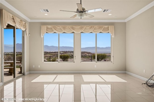 1348 Basin Vw, Mesquite, NV 89034 - unfurnished room with a mountain view, plenty of natural light, crown molding, a ceiling fan, and light tile patterned flooring