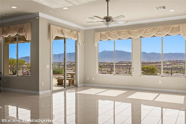 spare room with light tile patterned floors, visible vents, and a mountain view