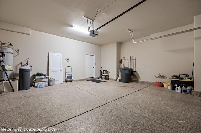 garage with strapped water heater and a garage door opener