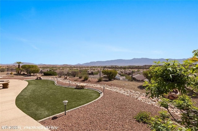 surrounding community featuring fence and a mountain view