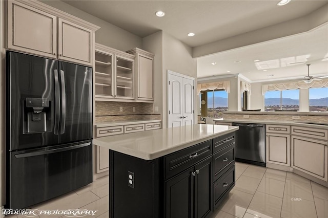 kitchen with stainless steel dishwasher, refrigerator with ice dispenser, light countertops, and light tile patterned floors