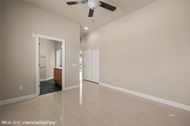 unfurnished bedroom with ensuite bathroom, baseboards, light tile patterned floors, and recessed lighting