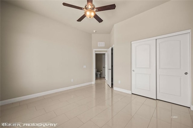 unfurnished bedroom featuring a closet, visible vents, baseboards, and light tile patterned flooring