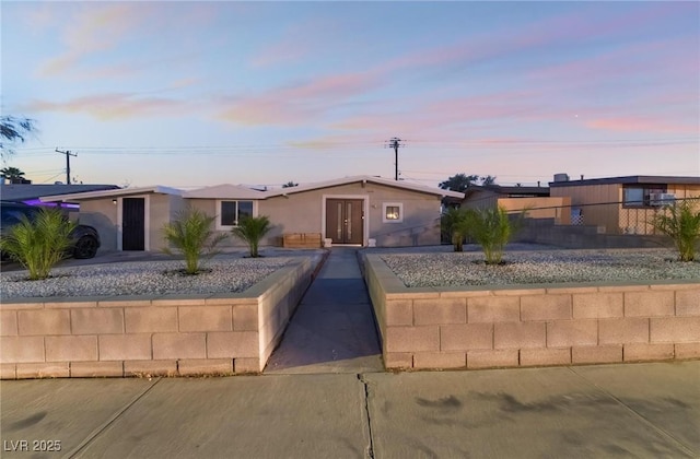 single story home featuring stucco siding and fence