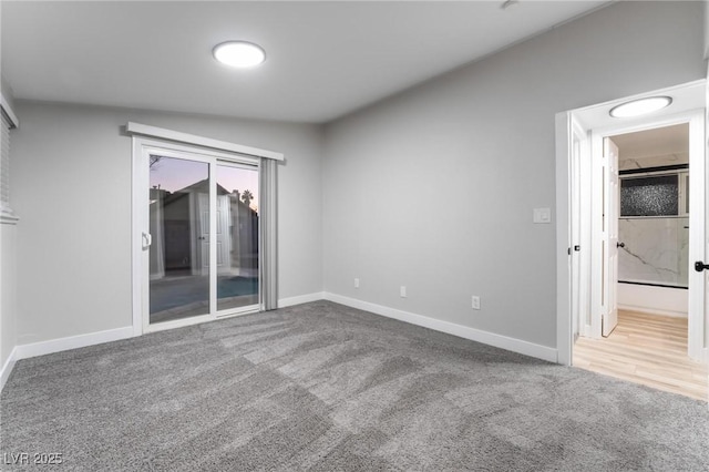 carpeted spare room with baseboards