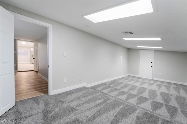 unfurnished room with light colored carpet, baseboards, and visible vents