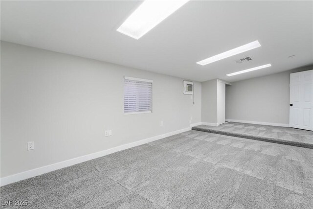 carpeted empty room with visible vents and baseboards