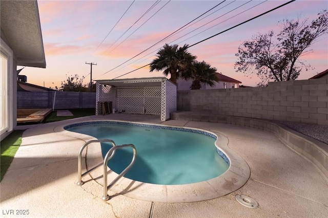pool at dusk with a fenced in pool, a patio area, and a fenced backyard