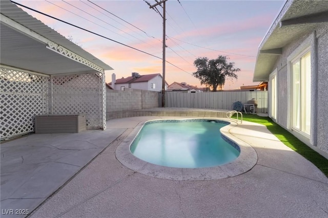 pool at dusk featuring a patio, a fenced backyard, and a fenced in pool