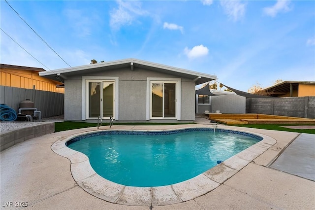 view of pool with a patio area, a fenced in pool, and fence