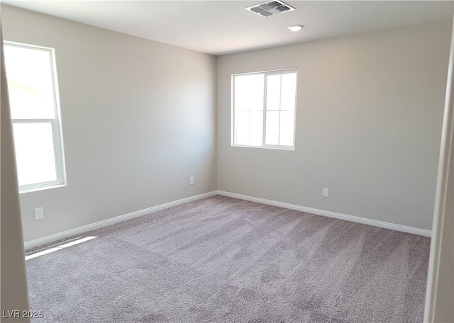 unfurnished room featuring carpet flooring, baseboards, and visible vents