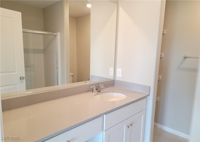 full bathroom featuring toilet, vanity, baseboards, and a stall shower