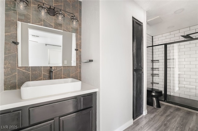 full bath featuring vanity, a stall shower, toilet, tile walls, and wood finished floors