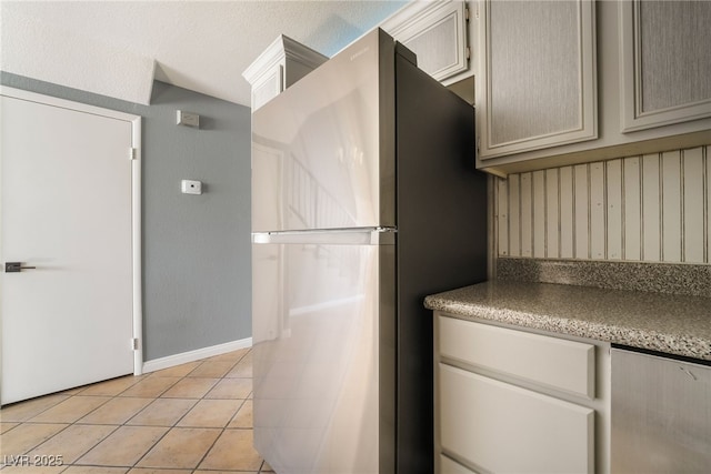 interior space with light tile patterned floors and baseboards