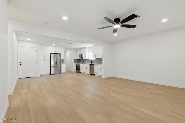 613 Kings Pl, Boulder City, NV 89005 - unfurnished living room featuring a ceiling fan, baseboards, recessed lighting, and light wood-style flooring