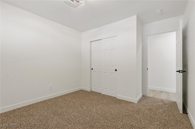 613 Kings Pl, Boulder City, NV 89005 - unfurnished bedroom featuring visible vents, baseboards, a closet, and light carpet