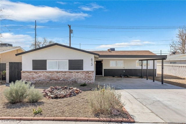 613 Kings Pl, Boulder City, NV 89005 - ranch-style home with concrete driveway, fence, a carport, and stucco siding