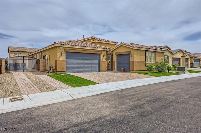 8318 Sonora Del Sol St, Las Vegas, NV 89113 - view of front of house featuring a gate, an attached garage, stucco siding, driveway, and a tile roof