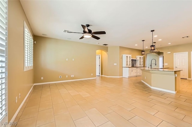 8318 Sonora Del Sol St, Las Vegas, NV 89113 - unfurnished living room with a ceiling fan, arched walkways, a sink, baseboards, and recessed lighting