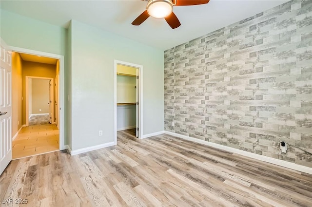 8318 Sonora Del Sol St, Las Vegas, NV 89113 - unfurnished bedroom featuring an accent wall, wallpapered walls, baseboards, wood finished floors, and a closet