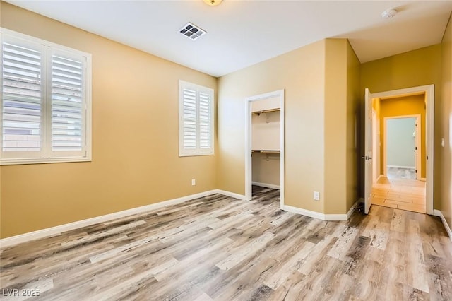8318 Sonora Del Sol St, Las Vegas, NV 89113 - unfurnished bedroom with wood finished floors, baseboards, a closet, and a spacious closet