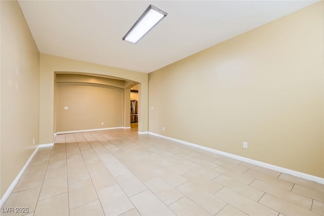 8318 Sonora Del Sol St, Las Vegas, NV 89113 - empty room with arched walkways, baseboards, and light tile patterned flooring