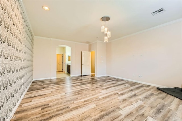 8318 Sonora Del Sol St, Las Vegas, NV 89113 - unfurnished room featuring arched walkways, light wood finished floors, wallpapered walls, ornamental molding, and baseboards