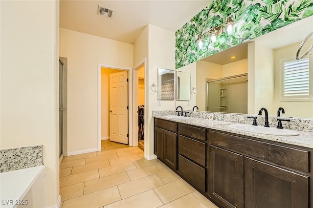 8318 Sonora Del Sol St, Las Vegas, NV 89113 - bathroom featuring a stall shower, tile patterned floors, double vanity, a spacious closet, and baseboards