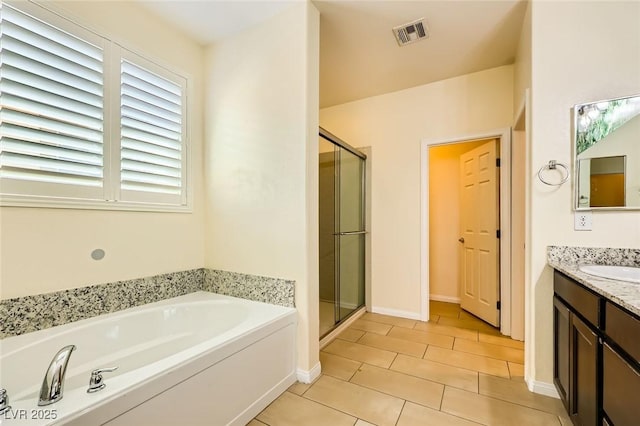 8318 Sonora Del Sol St, Las Vegas, NV 89113 - full bathroom featuring vanity, a garden tub, a stall shower, and tile patterned flooring