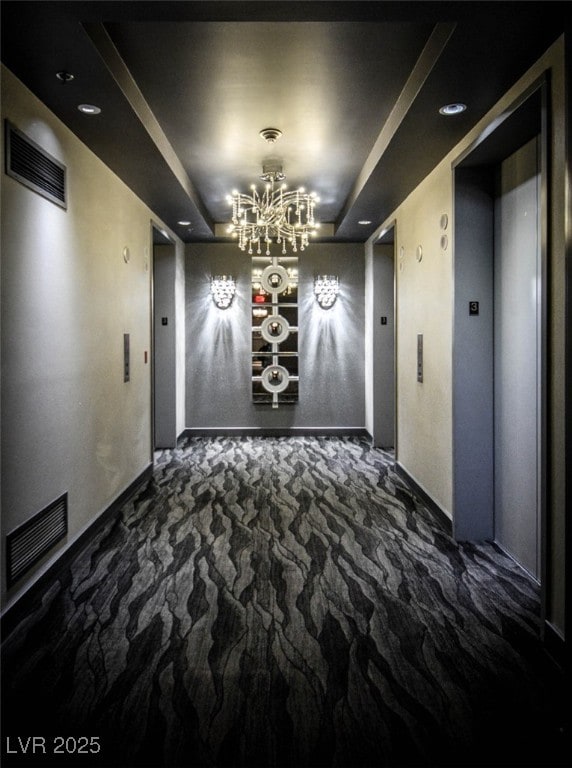 4525 Dean Martin Dr Unit 1103, Las Vegas, NV 89103 - unfurnished dining area with elevator, a chandelier, baseboards, a tray ceiling, and visible vents