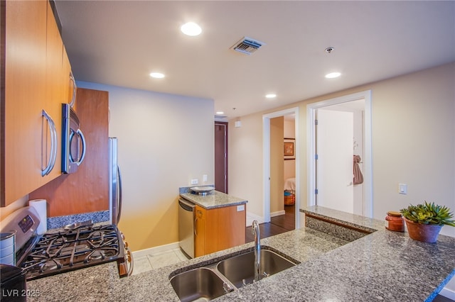 4525 Dean Martin Dr Unit 1103, Las Vegas, NV 89103 - kitchen with visible vents, stone countertops, recessed lighting, a sink, and appliances with stainless steel finishes