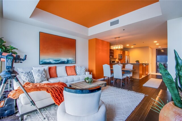 4525 Dean Martin Dr Unit 1103, Las Vegas, NV 89103 - living area featuring visible vents, recessed lighting, a raised ceiling, a chandelier, and hardwood / wood-style flooring