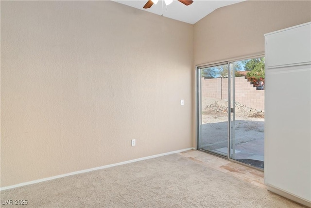 spare room featuring baseboards, ceiling fan, lofted ceiling, and light colored carpet