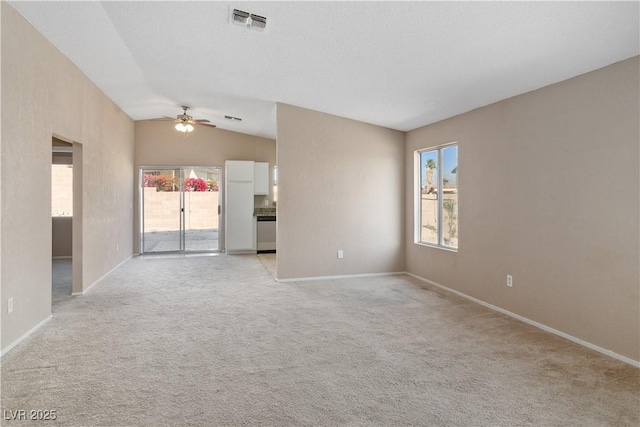 spare room with a healthy amount of sunlight, visible vents, ceiling fan, and baseboards