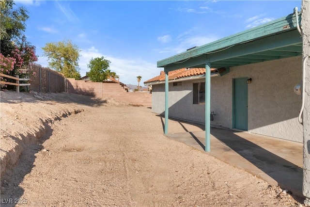 view of yard featuring fence and a patio