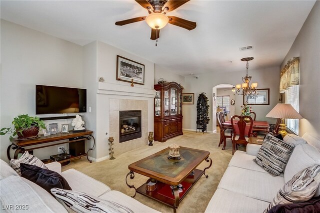 448 Bright Moon Ave, North Las Vegas, NV 89084 - living room featuring arched walkways, a chandelier, light carpet, and ceiling fan