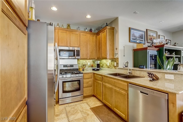448 Bright Moon Ave, North Las Vegas, NV 89084 - kitchen with appliances with stainless steel finishes, a sink, tasteful backsplash, a peninsula, and recessed lighting