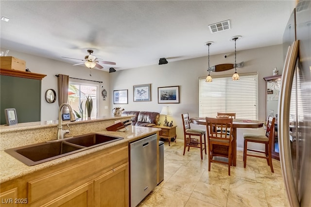 448 Bright Moon Ave, North Las Vegas, NV 89084 - kitchen with stainless steel appliances, a sink, a ceiling fan, and decorative light fixtures