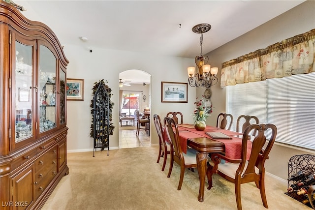 448 Bright Moon Ave, North Las Vegas, NV 89084 - dining area with a chandelier, light carpet, arched walkways, and baseboards