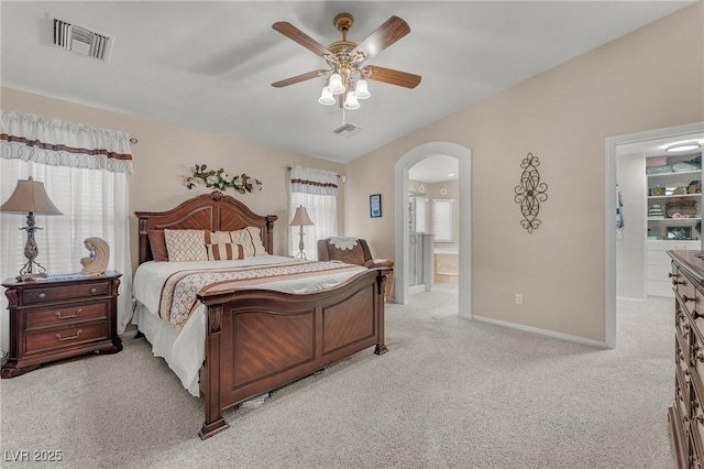4878 Friar Tuck Ave, Las Vegas, NV 89130 - bedroom featuring light colored carpet, arched walkways, baseboards, ceiling fan, and ensuite bathroom