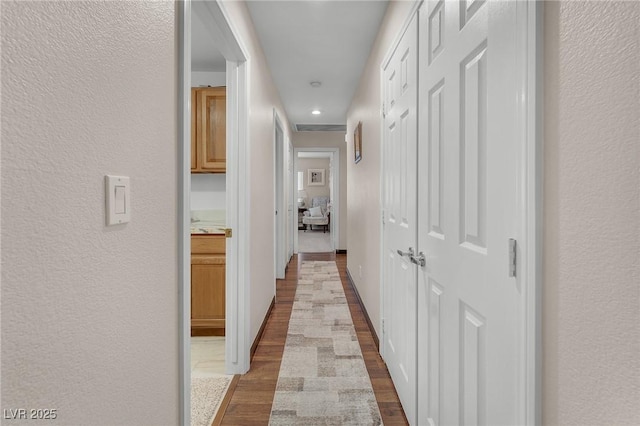 4878 Friar Tuck Ave, Las Vegas, NV 89130 - corridor with dark wood-type flooring, a textured wall, and recessed lighting