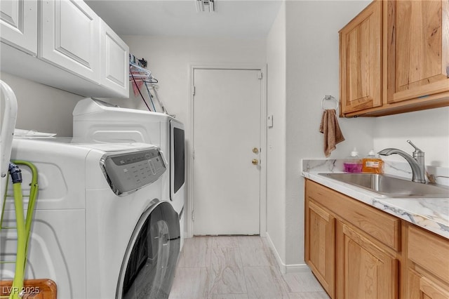 4878 Friar Tuck Ave, Las Vegas, NV 89130 - laundry room with washing machine and clothes dryer, cabinet space, and light marble finish floors