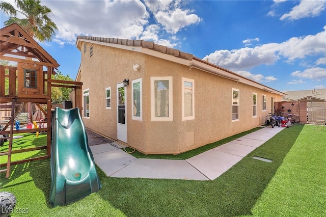 4878 Friar Tuck Ave, Las Vegas, NV 89130 - view of property exterior featuring a playground and stucco siding