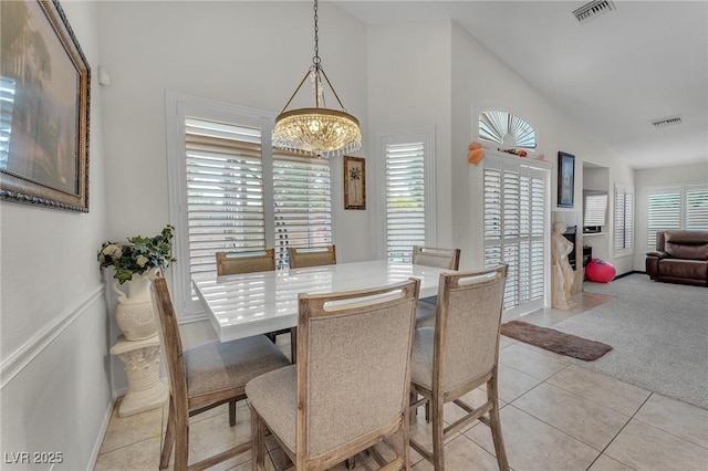4878 Friar Tuck Ave, Las Vegas, NV 89130 - dining space featuring a chandelier, light tile patterned flooring, baseboards, light carpet, and high vaulted ceiling