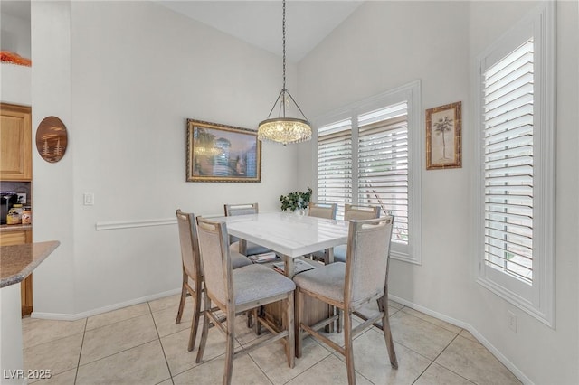4878 Friar Tuck Ave, Las Vegas, NV 89130 - dining area with high vaulted ceiling, a chandelier, baseboards, and light tile patterned floors