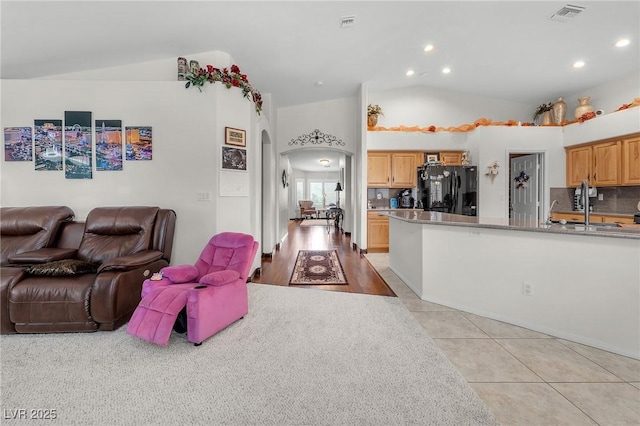 4878 Friar Tuck Ave, Las Vegas, NV 89130 - living room featuring lofted ceiling, arched walkways, light tile patterned floors, and recessed lighting
