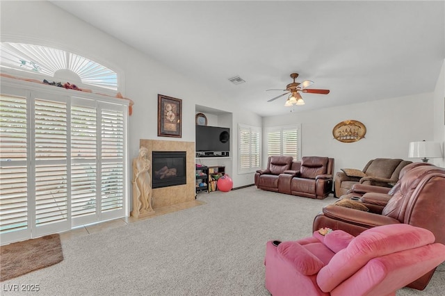 4878 Friar Tuck Ave, Las Vegas, NV 89130 - carpeted living area with a ceiling fan and a tiled fireplace